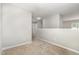 Upstairs loft with neutral paint, carpet, and a half wall overlooking a window with natural light at 2409 Valley Haven Dr, Raleigh, NC 27603