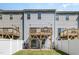 Back exterior view showcasing wooden decks, sliding doors, and a white fenced yard at 248 Amber Acorn Ave, Raleigh, NC 27603