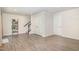 Finished basement area with LVP flooring, staircase, and doors for storage at 248 Amber Acorn Ave, Raleigh, NC 27603