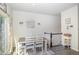 Bright dining area with a wooden table, comfortable seating, natural light, and modern decor at 248 Amber Acorn Ave, Raleigh, NC 27603