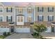 Charming townhome showcasing a brick and siding facade, inviting entrance, and an attached one-car garage at 248 Amber Acorn Ave, Raleigh, NC 27603