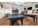 Spacious game room with a ping pong table, pool table, and multiple arcade-style game machines at 248 Amber Acorn Ave, Raleigh, NC 27603