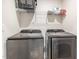 Modern laundry room featuring front loading washer and dryer with wire shelving at 248 Amber Acorn Ave, Raleigh, NC 27603