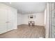 Open-concept living space with light LVP flooring and a closet with double doors at 248 Amber Acorn Ave, Raleigh, NC 27603
