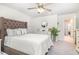 Comfortable main bedroom features a tufted headboard, soft bedding, neutral colors, and ample space at 248 Amber Acorn Ave, Raleigh, NC 27603