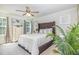 Cozy main bedroom with a tufted headboard, soft bedding, natural light, and serene ambiance at 248 Amber Acorn Ave, Raleigh, NC 27603