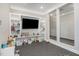 play room featuring built in shelving, television, toys, and a view into an adjacent play area at 248 Amber Acorn Ave, Raleigh, NC 27603