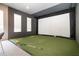 Indoor sports room with artificial turf flooring, projection screen, and padded walls at 248 Amber Acorn Ave, Raleigh, NC 27603