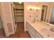 Charming bathroom with pink floral wallpaper and a double sink vanity at 2708 Coleberry Trl, Rocky Mount, NC 27804