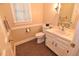 Well-lit bathroom featuring a toilet, sink, and a mirror at 2708 Coleberry Trl, Rocky Mount, NC 27804