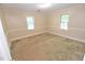 Bright bedroom with natural light from two windows, carpet floors, and neutral wall colors at 2708 Coleberry Trl, Rocky Mount, NC 27804