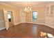 Formal dining room features hardwood floors, built-in cabinets, large window and elegant chandelier at 2708 Coleberry Trl, Rocky Mount, NC 27804
