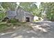 Spacious two-car garage with gray siding and mature landscaping in a wooded area at 2708 Coleberry Trl, Rocky Mount, NC 27804