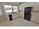 Bright kitchenette featuring white cabinets, black appliances, and ample counter space at 2708 Coleberry Trl, Rocky Mount, NC 27804