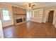 Inviting living room featuring hardwood floors, brick fireplace, built-in shelving, and large windows at 2708 Coleberry Trl, Rocky Mount, NC 27804