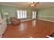 Inviting living room with hardwood floors, a ceiling fan, a comfortable chair and natural light at 2708 Coleberry Trl, Rocky Mount, NC 27804