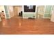Open-concept living area with hardwood floors, large-screen television, and seamless flow to adjacent spaces at 2708 Coleberry Trl, Rocky Mount, NC 27804