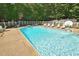 Backyard pool surrounded by lounge chairs, providing a relaxing oasis for outdoor enjoyment at 2708 Coleberry Trl, Rocky Mount, NC 27804