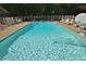 Inground pool with clear water with a diving board and surrounding lounge chairs and tables at 2708 Coleberry Trl, Rocky Mount, NC 27804
