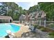 Backyard pool with diving board, patio seating, and mature trees providing a private oasis at 2708 Coleberry Trl, Rocky Mount, NC 27804