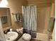 Neutral bathroom featuring updated vanity and shower/tub combo with a patterned shower curtain at 2915 Ross Rd, Durham, NC 27703