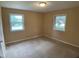 Bedroom featuring neutral carpeting and two large windows offering plenty of natural light at 2915 Ross Rd, Durham, NC 27703