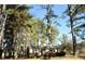 Charming brick home nestled among mature trees, featuring a well-kept front yard at 2915 Ross Rd, Durham, NC 27703