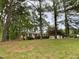 Quaint brick home nestled amongst mature trees, offering shade and privacy at 2915 Ross Rd, Durham, NC 27703