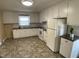 Spacious kitchen featuring white cabinets, laminate countertops, and updated appliances at 2915 Ross Rd, Durham, NC 27703