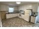 Traditional kitchen featuring white cabinets, laminate countertops, and updated appliances at 2915 Ross Rd, Durham, NC 27703