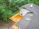 Aerial view of home with large wooden deck surrounded by lush trees and a well-maintained roof at 301 Lord Berkley Rd, Raleigh, NC 27610