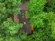 Expansive aerial view showing the home nestled among lush trees, offering a serene and private setting at 301 Lord Berkley Rd, Raleigh, NC 27610