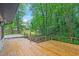 Expansive wooden deck with a picturesque backyard view, ideal for enjoying serene outdoor living and entertaining guests at 301 Lord Berkley Rd, Raleigh, NC 27610