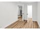 Spacious basement featuring wood floors and open doors, perfect for versatile living and storage solutions at 301 Lord Berkley Rd, Raleigh, NC 27610