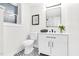 Well-lit bathroom featuring a stylish vanity, modern mirror, and decorative black and white patterned tile flooring at 301 Lord Berkley Rd, Raleigh, NC 27610