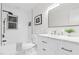 Bathroom featuring white cabinets, modern fixtures, and sleek white subway tile at 301 Lord Berkley Rd, Raleigh, NC 27610