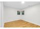 Bright bedroom with wood floors, white walls, and a window with tree views at 301 Lord Berkley Rd, Raleigh, NC 27610