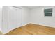 Well-lit bedroom showcasing hardwood floors and large closet at 301 Lord Berkley Rd, Raleigh, NC 27610