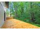 Large wooden deck adjacent to a home, providing a serene outdoor space with scenic views of lush greenery and trees at 301 Lord Berkley Rd, Raleigh, NC 27610