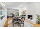 Formal dining room with decorative fireplace and open view of a living room with abundant natural light at 301 Lord Berkley Rd, Raleigh, NC 27610