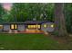 Charming home featuring a brick exterior, front porch, mature trees, and inviting curb appeal at 301 Lord Berkley Rd, Raleigh, NC 27610