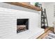 Close up of fireplace with wood accent and decorative shelving unit at 301 Lord Berkley Rd, Raleigh, NC 27610
