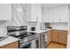 The kitchen features quartz countertops, stainless steel appliances, and ample cabinet space at 301 Lord Berkley Rd, Raleigh, NC 27610