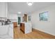Bright kitchen featuring white cabinets, hardwood floors, and a marble island with wooden accents at 301 Lord Berkley Rd, Raleigh, NC 27610