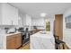 Modern kitchen with white marble countertops, stainless steel appliances, and light hardwood flooring at 301 Lord Berkley Rd, Raleigh, NC 27610