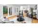 Comfortable living room with access to backyard through french doors and view to an open dining area at 301 Lord Berkley Rd, Raleigh, NC 27610