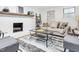 Comfortable living room featuring a brick fireplace and stylish decor at 301 Lord Berkley Rd, Raleigh, NC 27610