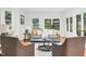 Cozy living room with two chairs, a sofa, and a view of the backyard through ample windows at 301 Lord Berkley Rd, Raleigh, NC 27610