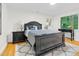 Well-lit main bedroom featuring a dark wood bed frame, bedside tables and a bright window at 301 Lord Berkley Rd, Raleigh, NC 27610