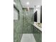Shower featuring green tile, dual showerheads, and a built-in niche at 301 Lord Berkley Rd, Raleigh, NC 27610